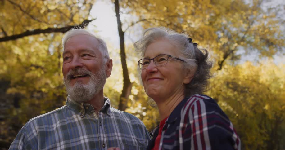 A man and woman turn and smile