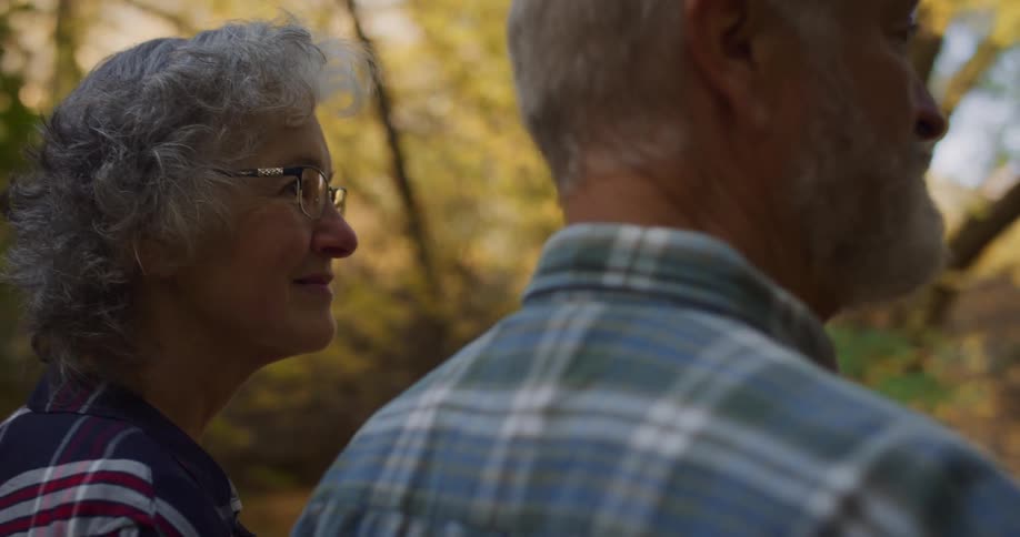 A couple hike together in the woods