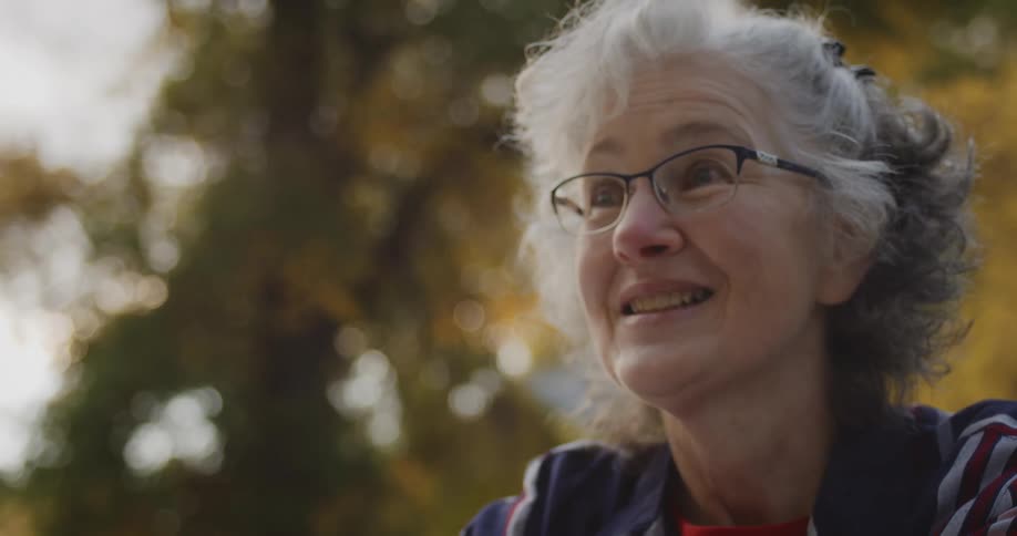 A woman smiles and talks