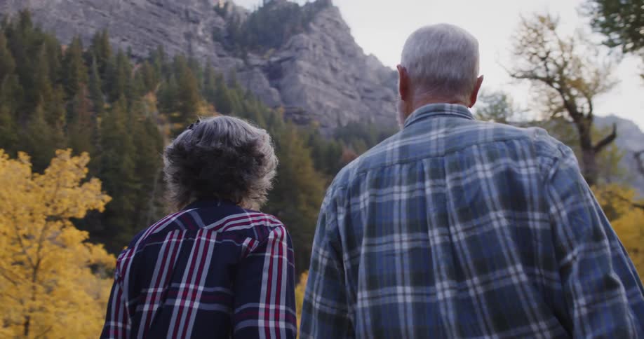 A man and woman are hiking near the mountain