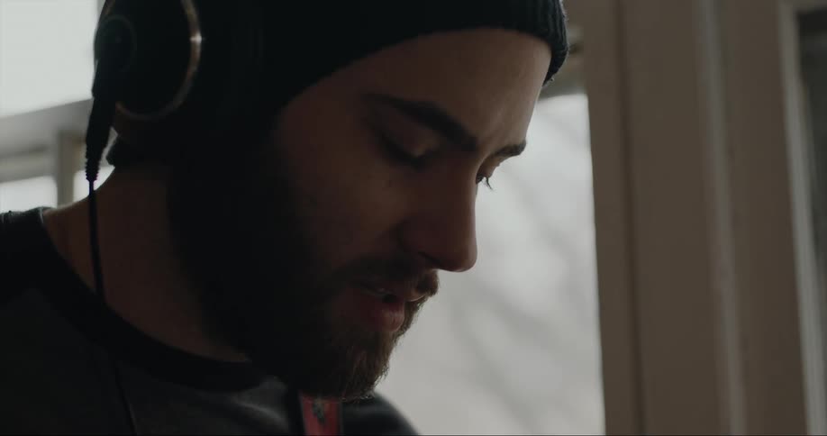 A man is listening to music on his headphones