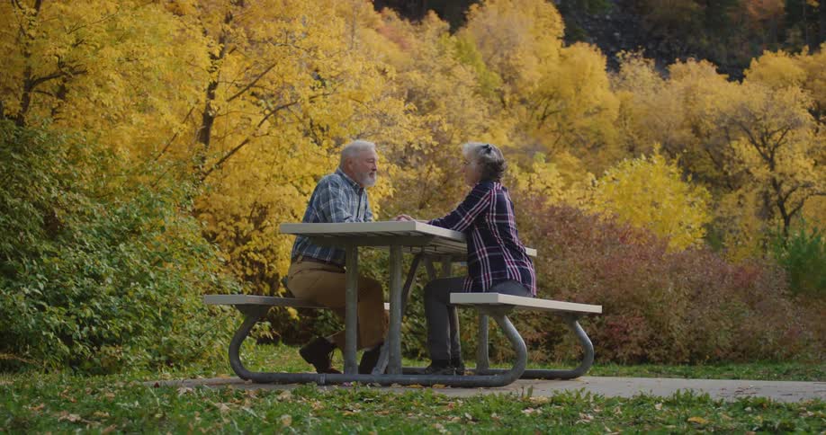 A man and woman sitting outside talking