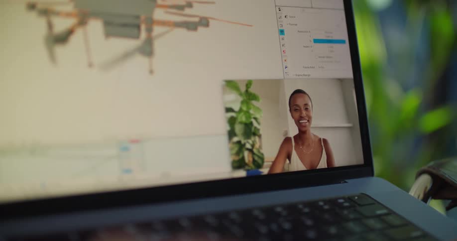 A woman in a room talking on a laptop