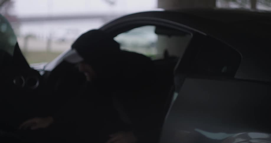 A man slowly gets out of a car