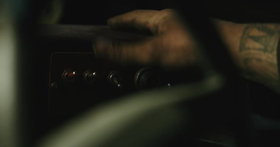 A person is pressing buttons in the car at night time