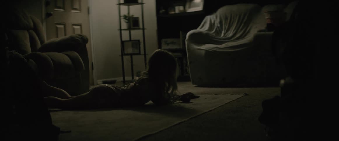 A child is playing on the living room floor