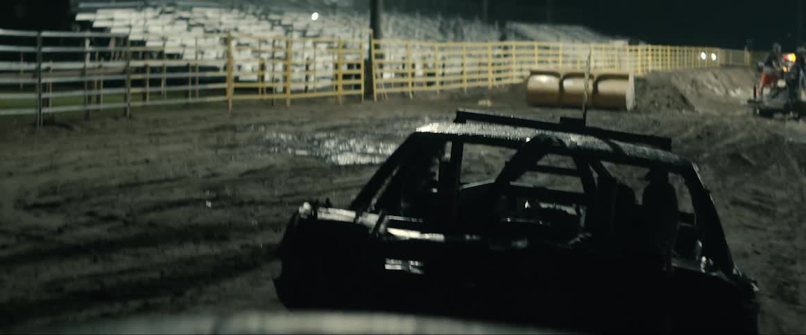 There is a car getting dragged outside in the night time