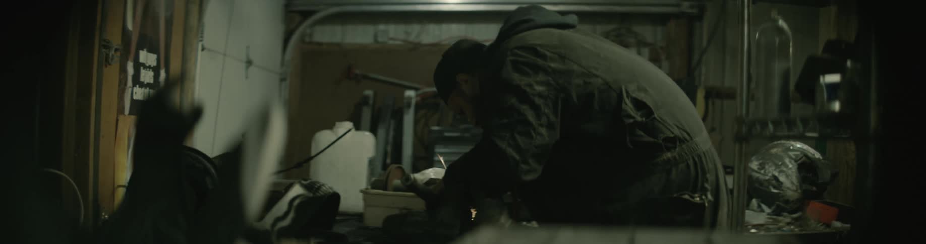 A man is working with tools in a room by himself