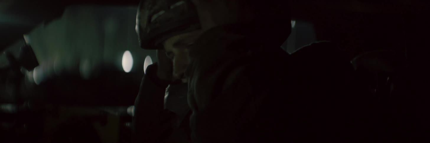 Bearded competition driver puts on his crash helmet while sitting in vehicle
