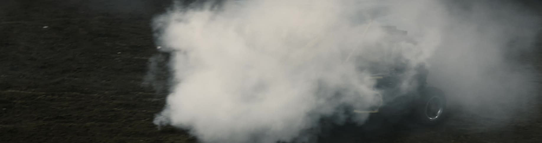 Smoke fills the air as cars crash in to one another during a demolition derby