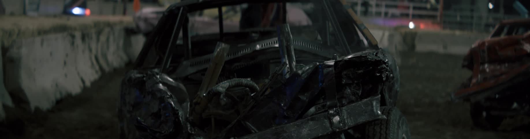 The wrecked vehicle is smoking in the stadium