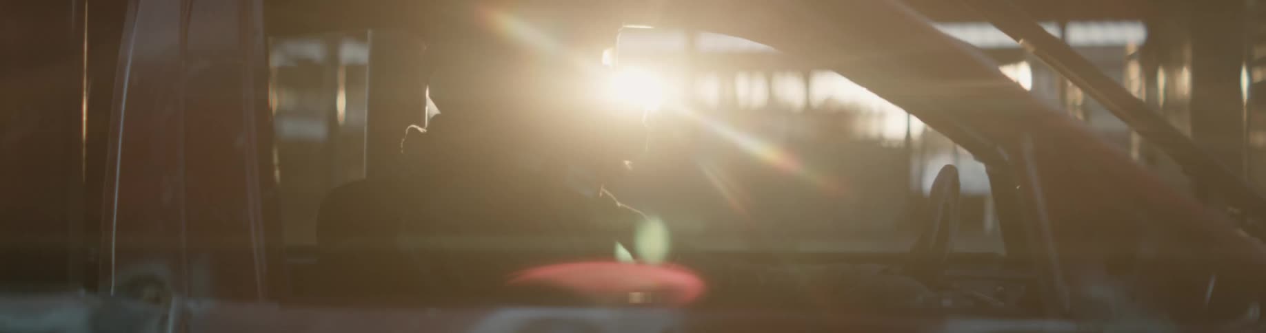 A racecar driver sits in their car before a race