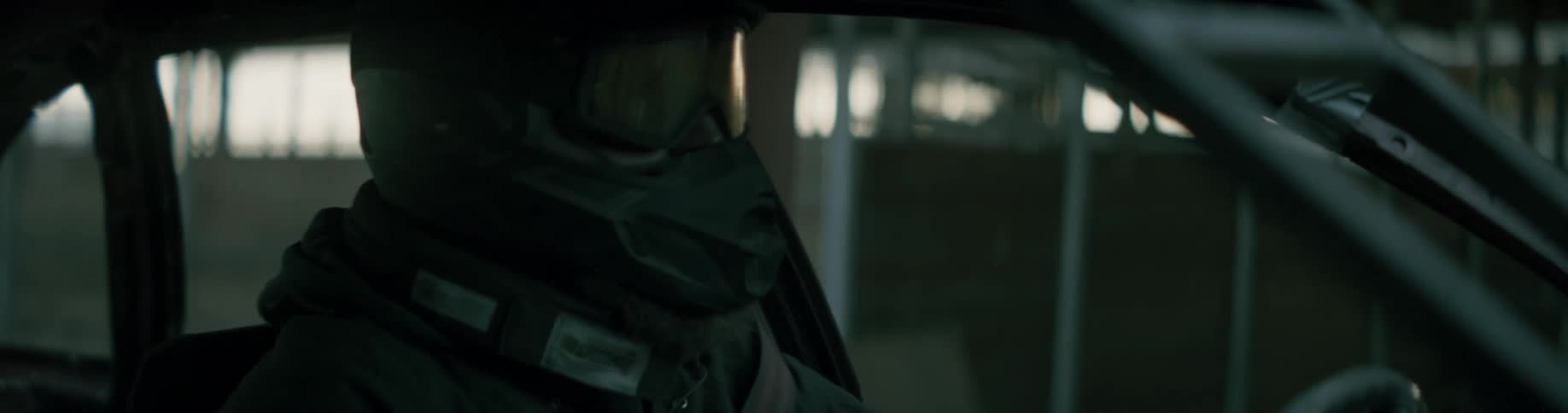 A man with a helmet on is sitting in a race car and waiting