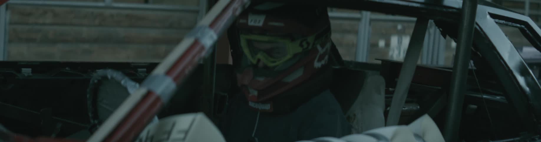 A race car driver sits in his car