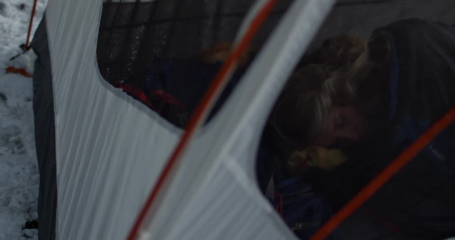 Woman sleeps in tent