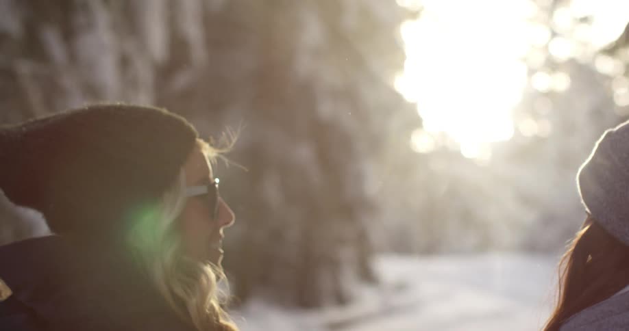 Two women walking down a snowy street