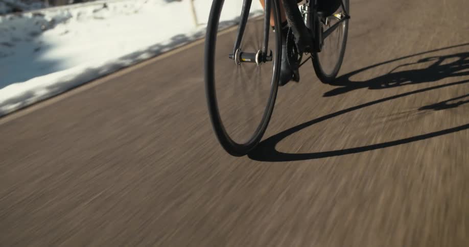 A man riding a bike down a road