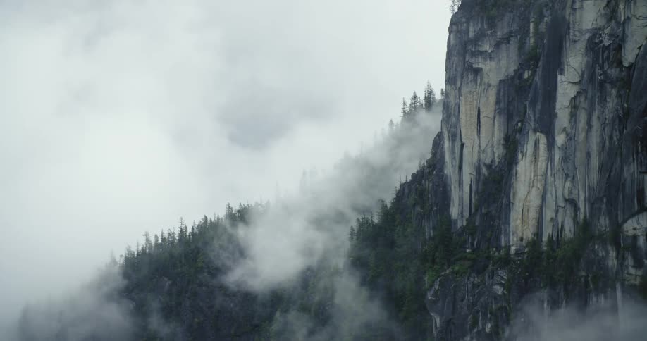 A view of clouds next to a mountain