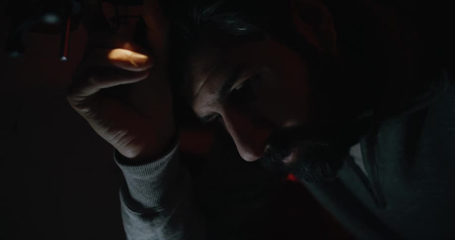 A photographer in a darkroom looking down