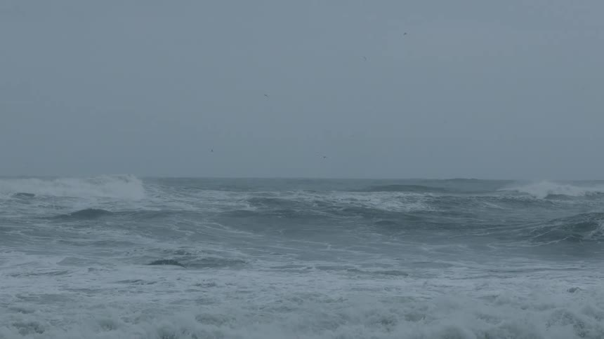 Waves churn up froth as they roll along