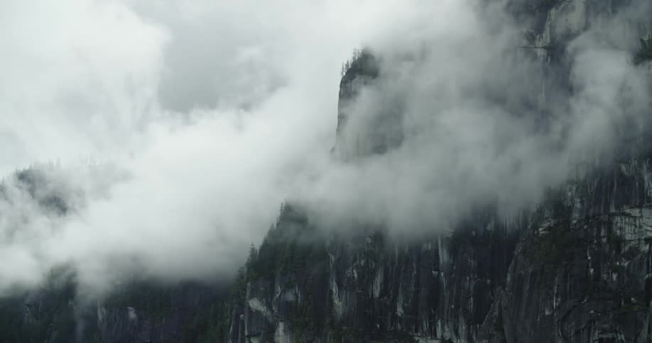 Dense fog moves over a mountain range