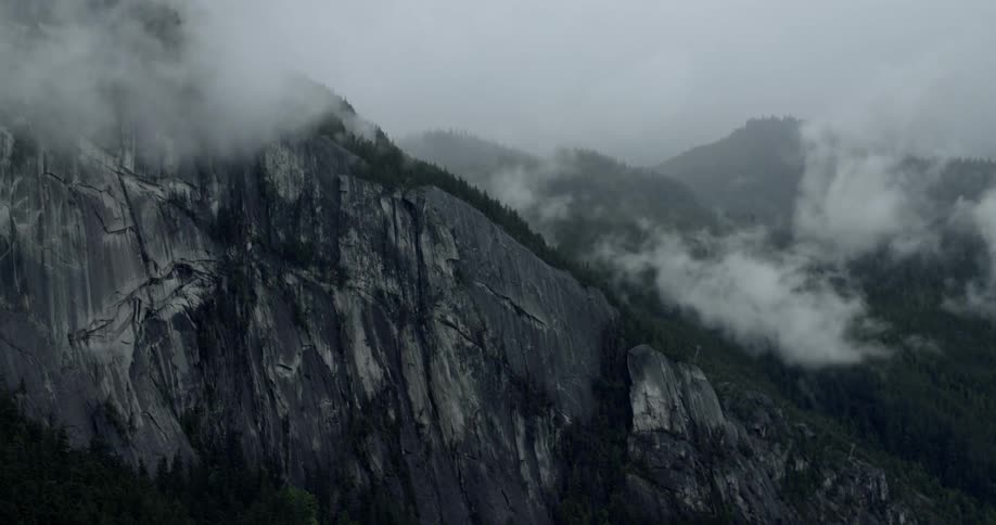 A time lapse of clouds moving over a cliff