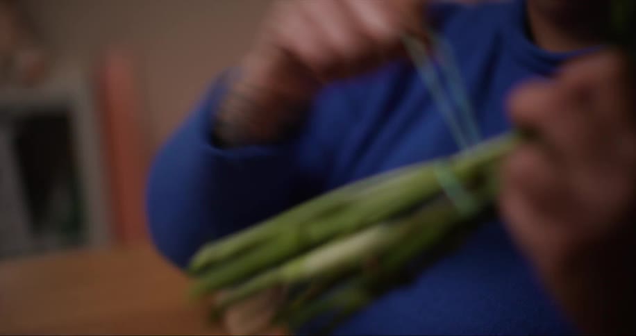 A woman puts a rubber band on a bouquet of flowers