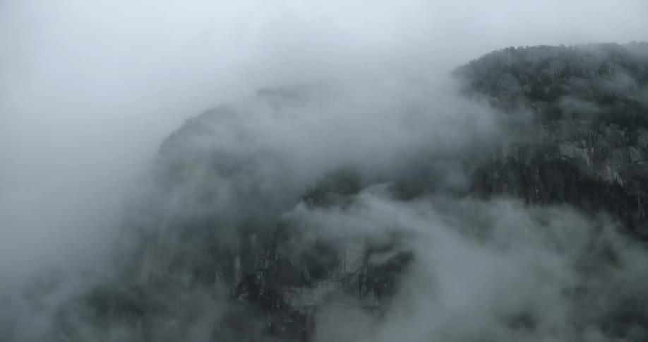 The clouds flow over the mountain