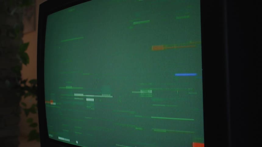Green static plays on a tube style television