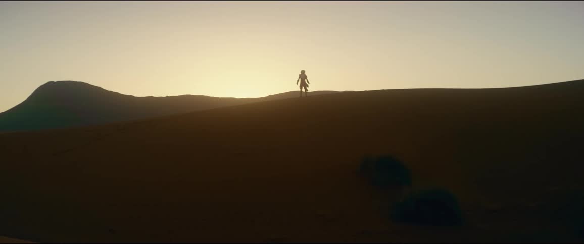 A man is walking in the desert