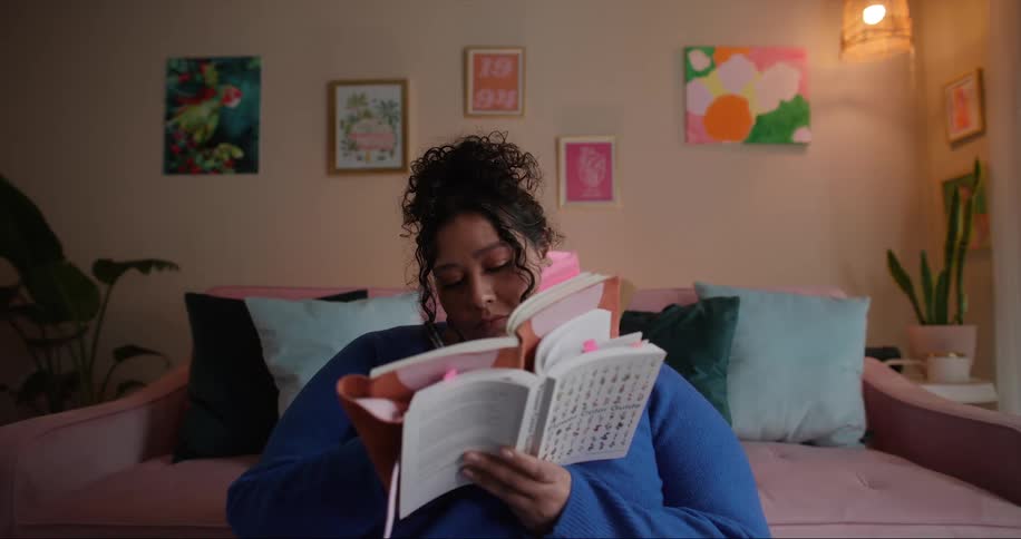 A woman is taking notes in a book