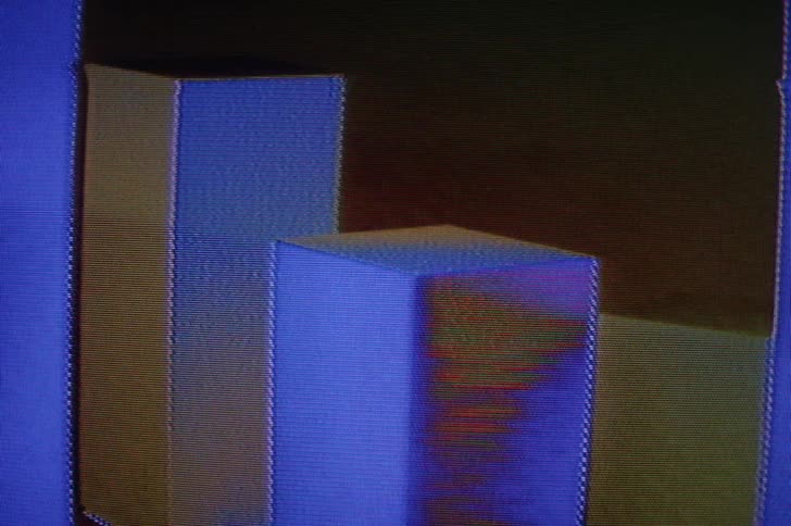 A distorted image of blue rectangle pedestals flashing and pixelating