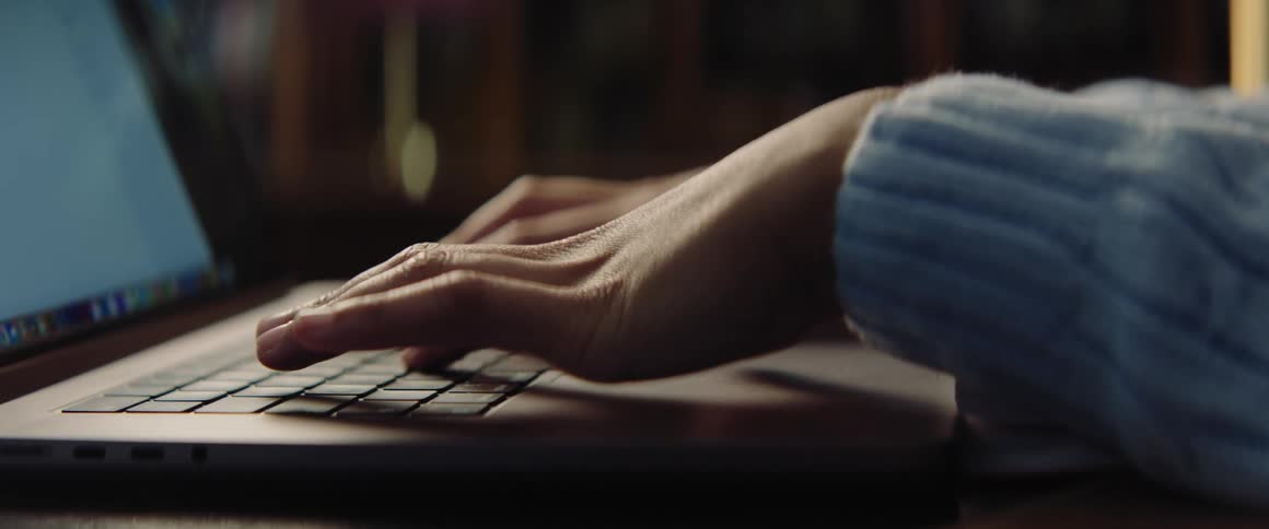 A person is typing on the laptop