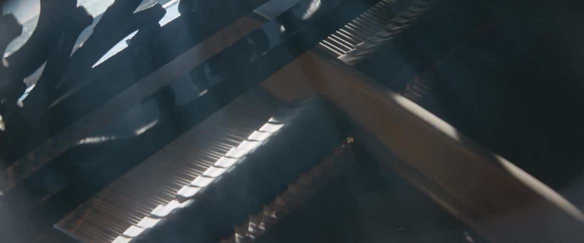 Hammers hit strings on the inside of a piano as it is being played