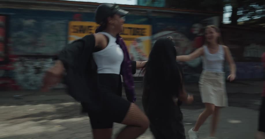 Friends run down the alley together