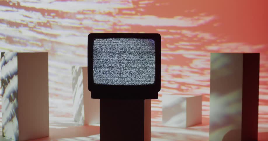 A television with static sits on a beam while chaotic flashing of red with white lines occurs all around it