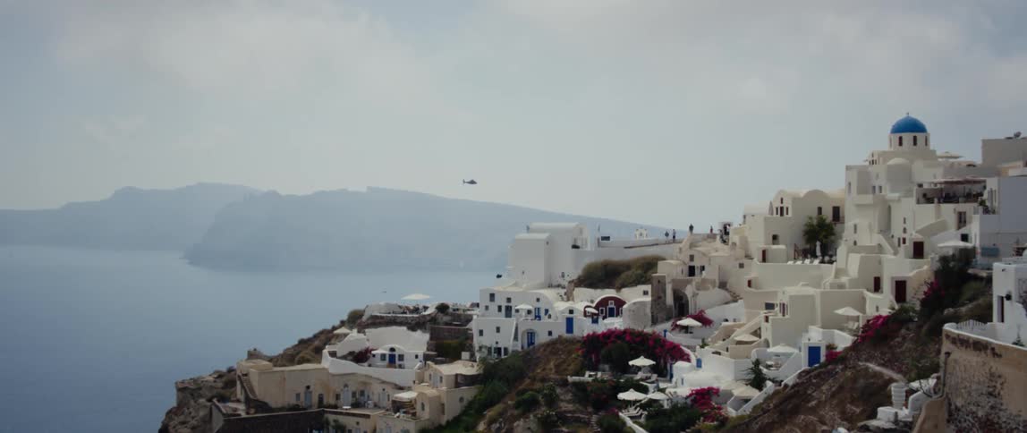 A helicopter flies over a neighborhood on the shore