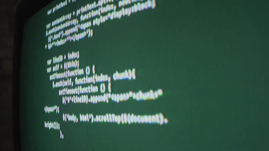The monitor is displaying code