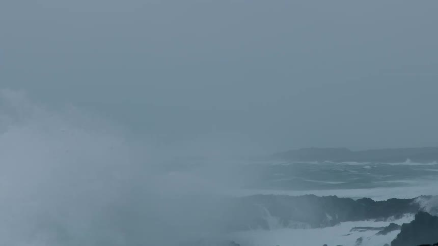 Heavy waves crash against the shore