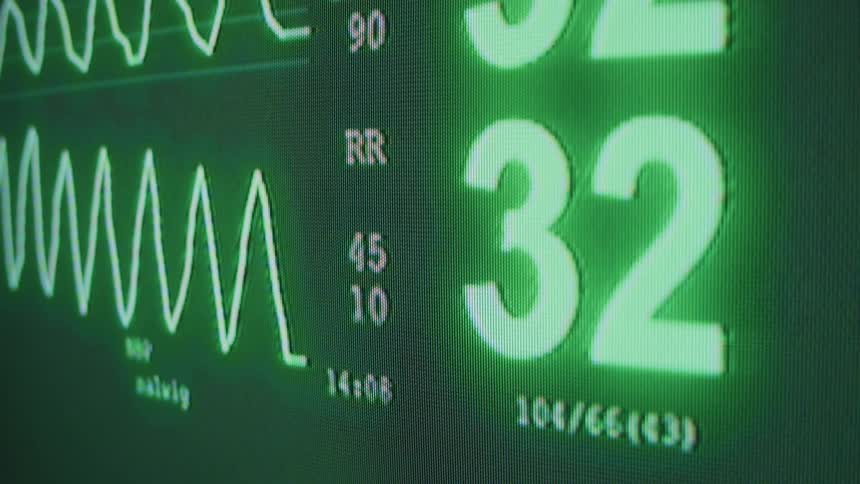 An electronic medical device shows heart rate and blood pressure