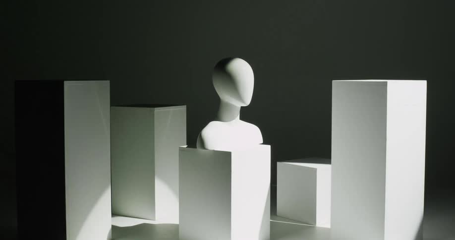 Light flows across mannequin bust and blocks briefly turning area bright then leaving it in darkness