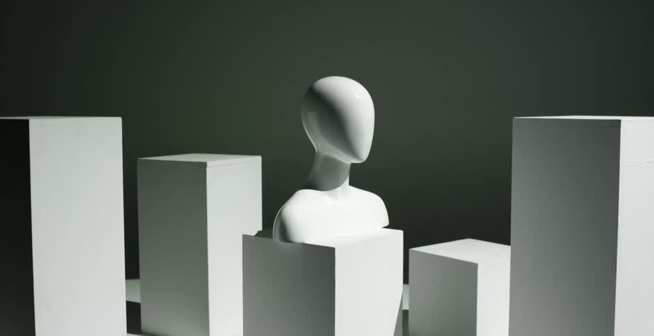 A bust sitting on a wooden block in a room