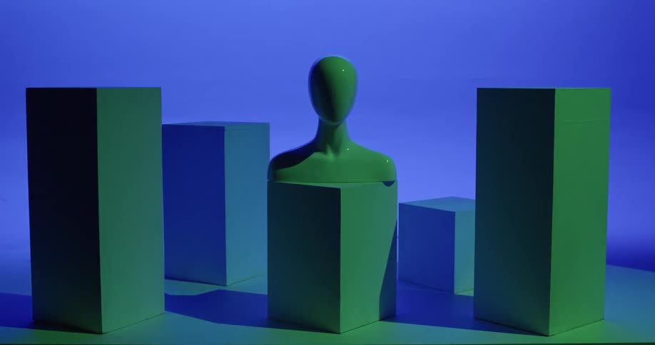 Lights change different primary colors in a room with a bust and pedestals