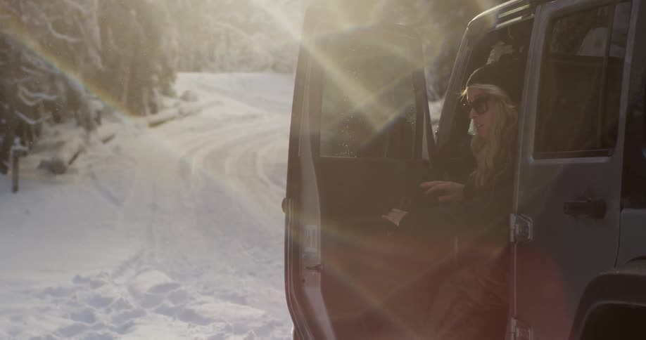 A woman gets out of a vehicle