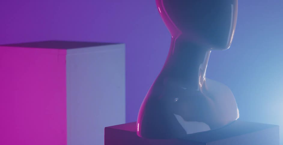 Colorful lights glow and shine on cubes and a mannequin bust