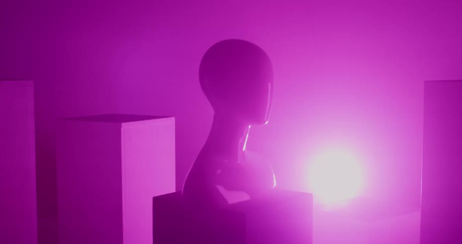 A view of a sculpture in a room with a colorful strobe