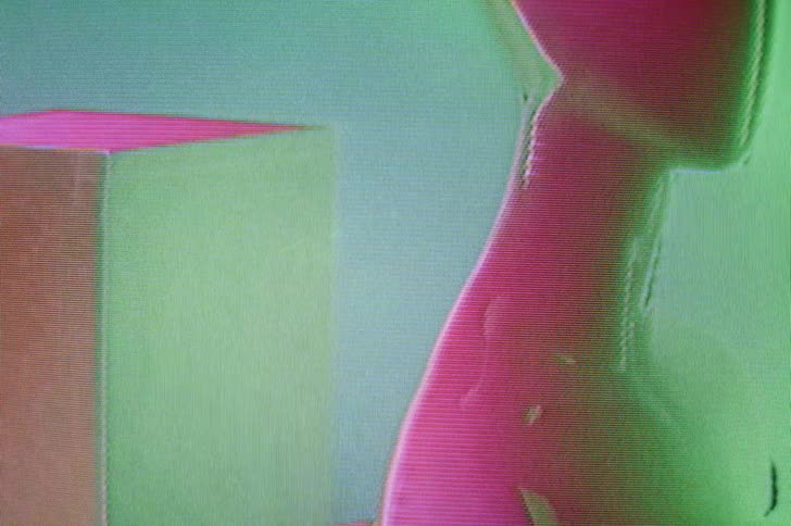 An image of a mannequin bust form distorts and warps as light and color flash