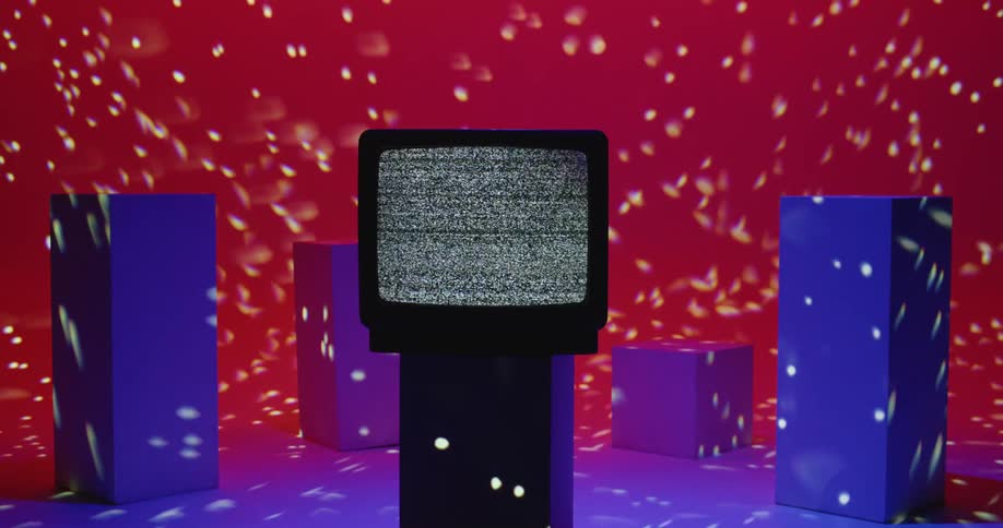 Static plays on a tube style television sitting on a pedestal as star shaped lights are projected in the room