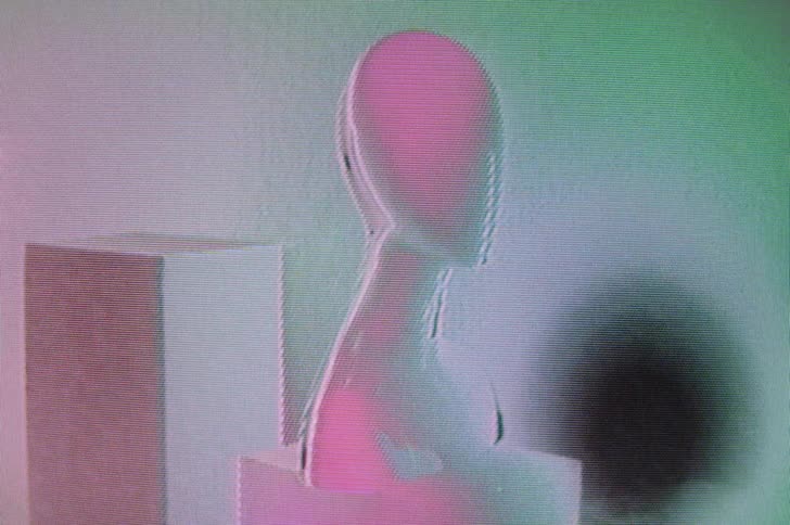 Colorful lights flashing on a mannequin bust in a scene that is chaotic and distorting
