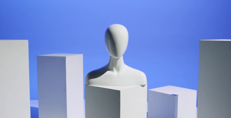 Lights change in primary colors in a room where a human bust sits on a rectangle